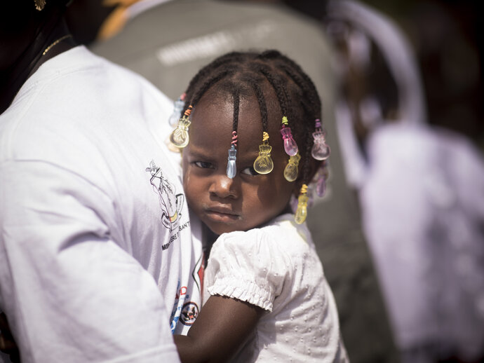 Photo: Toby Madden / MMV Photo: Little girl at the back of caregiver