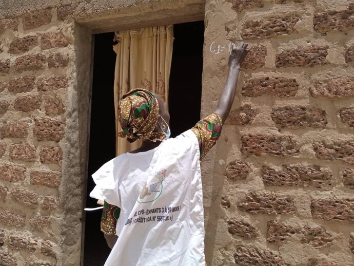 Photo: Health worker marking SMC eligible households