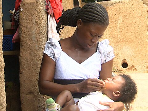 Photo: Mother administering SMC to baby